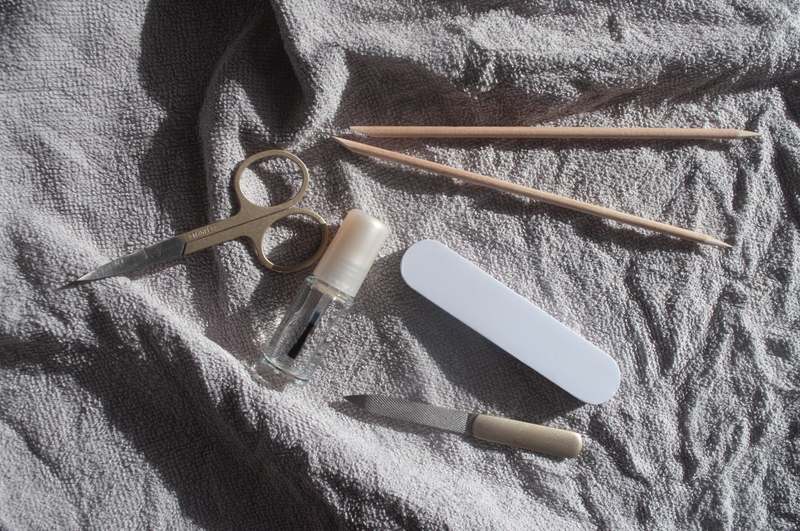 Team of diverse nail professionals holding various nail scissors in a bright, clean studio